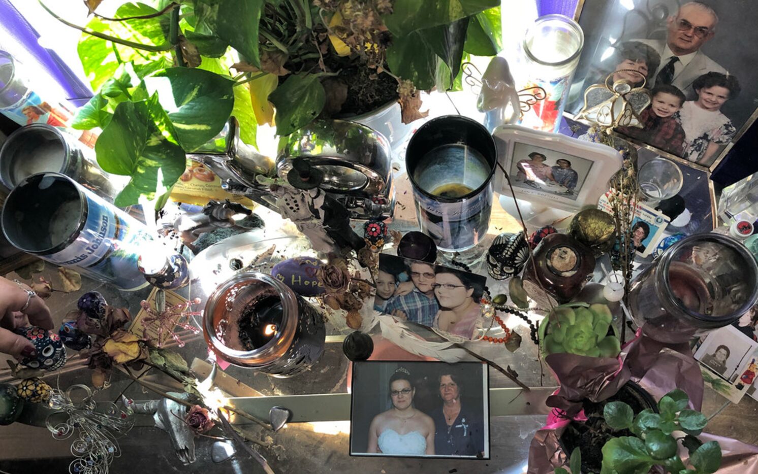 A table of remembrances sits near a window in the home of Kati Wall, who lost her parents...