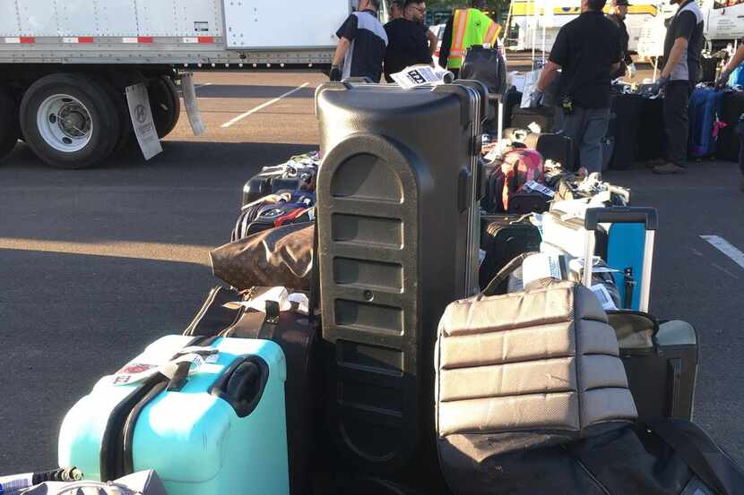 
Workers at Sky Harbor International Airport in Phoenix load luggage on a semi truck on May...
