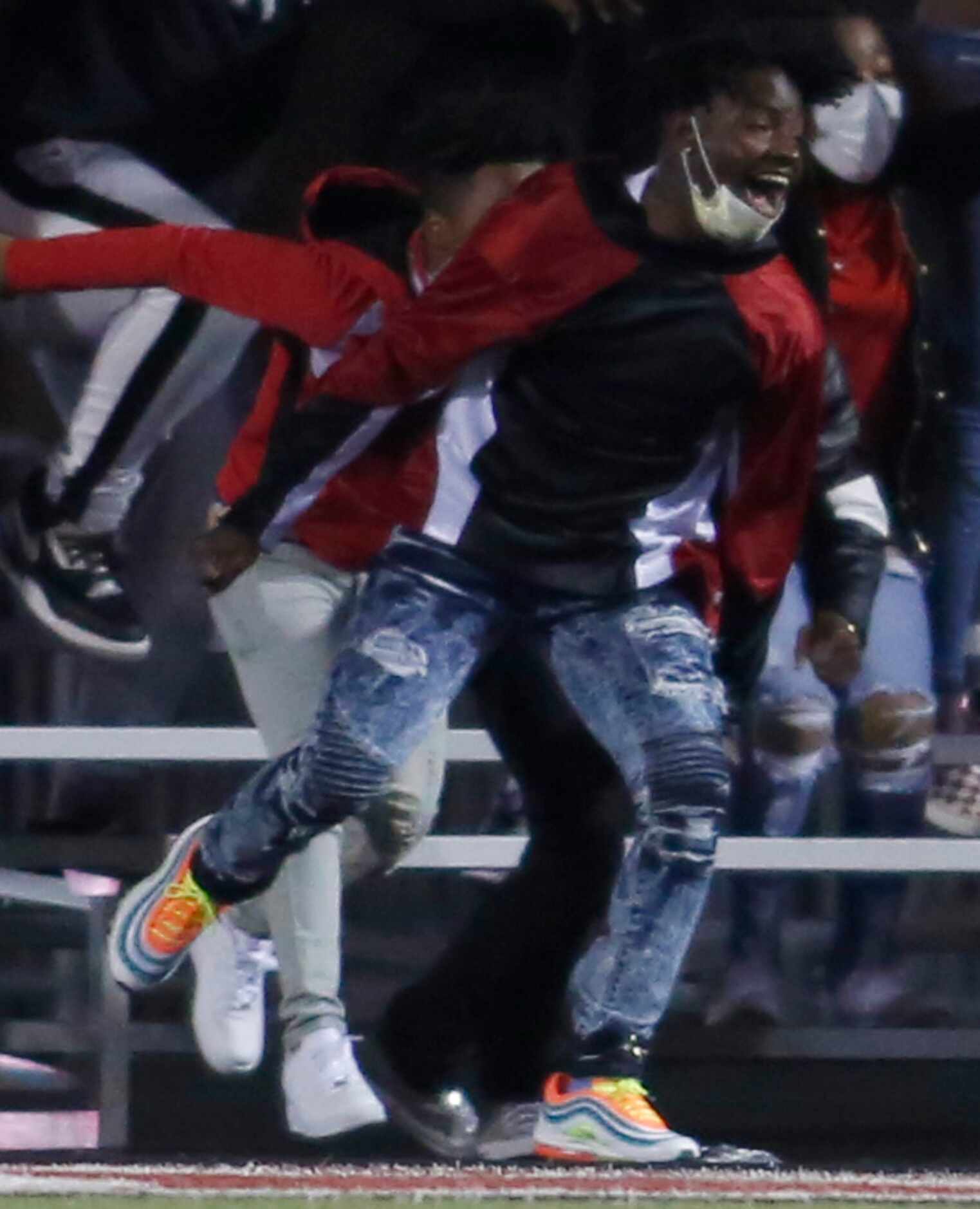 A Cedar Hill Longhorns fan erupts after quarterback Kaidon Salter tossed a first quarter...