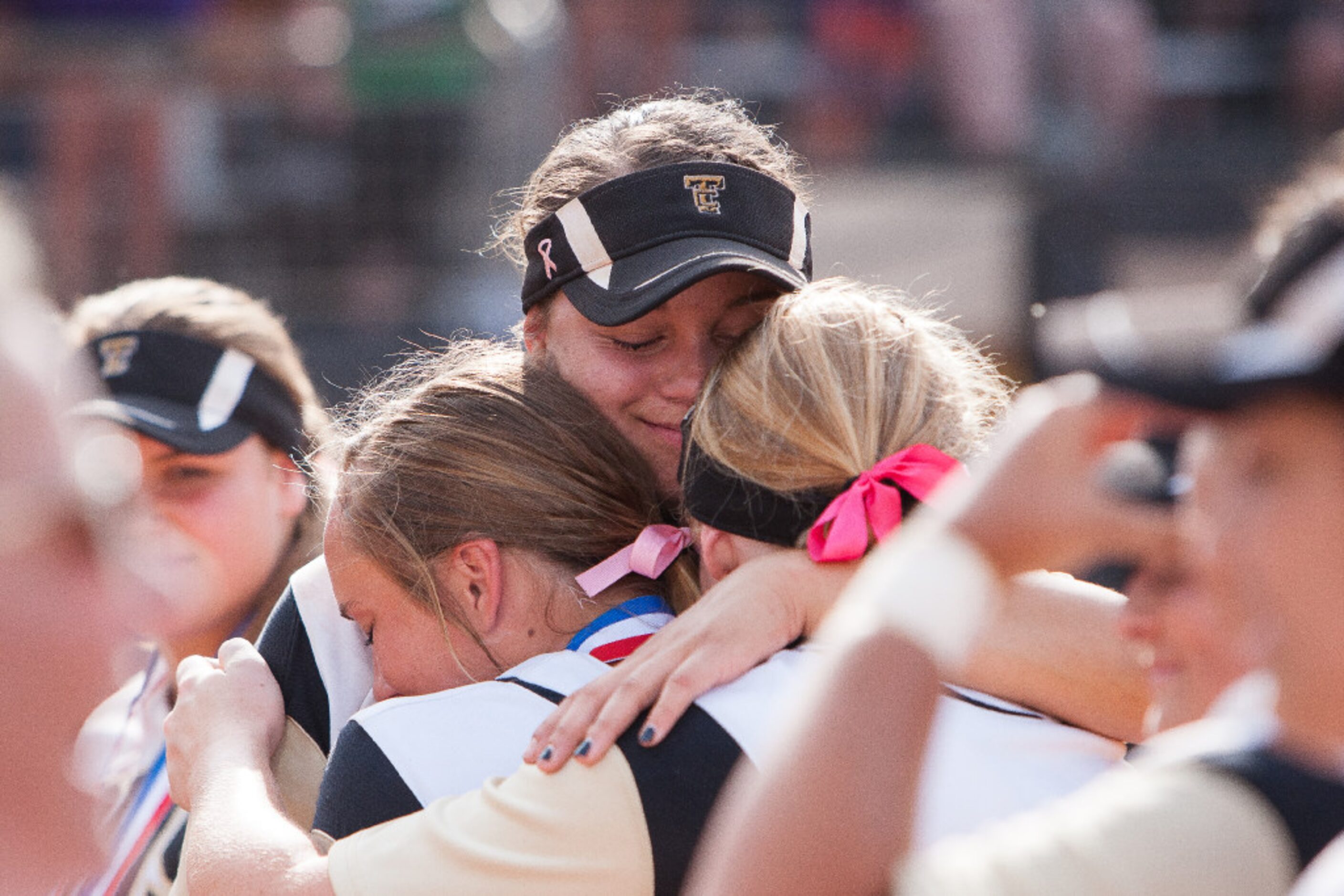 The Colony's Jayda Coleman, center, embraces teammates after the medal ceremony during the...