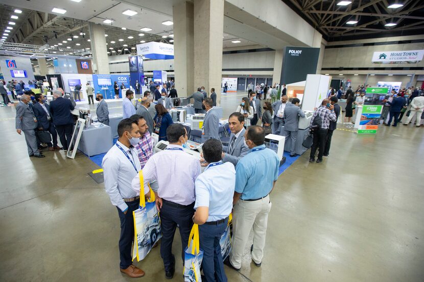 Attendees browse HVAC systems from a vendor at the Asian American Hotel Owners Association...