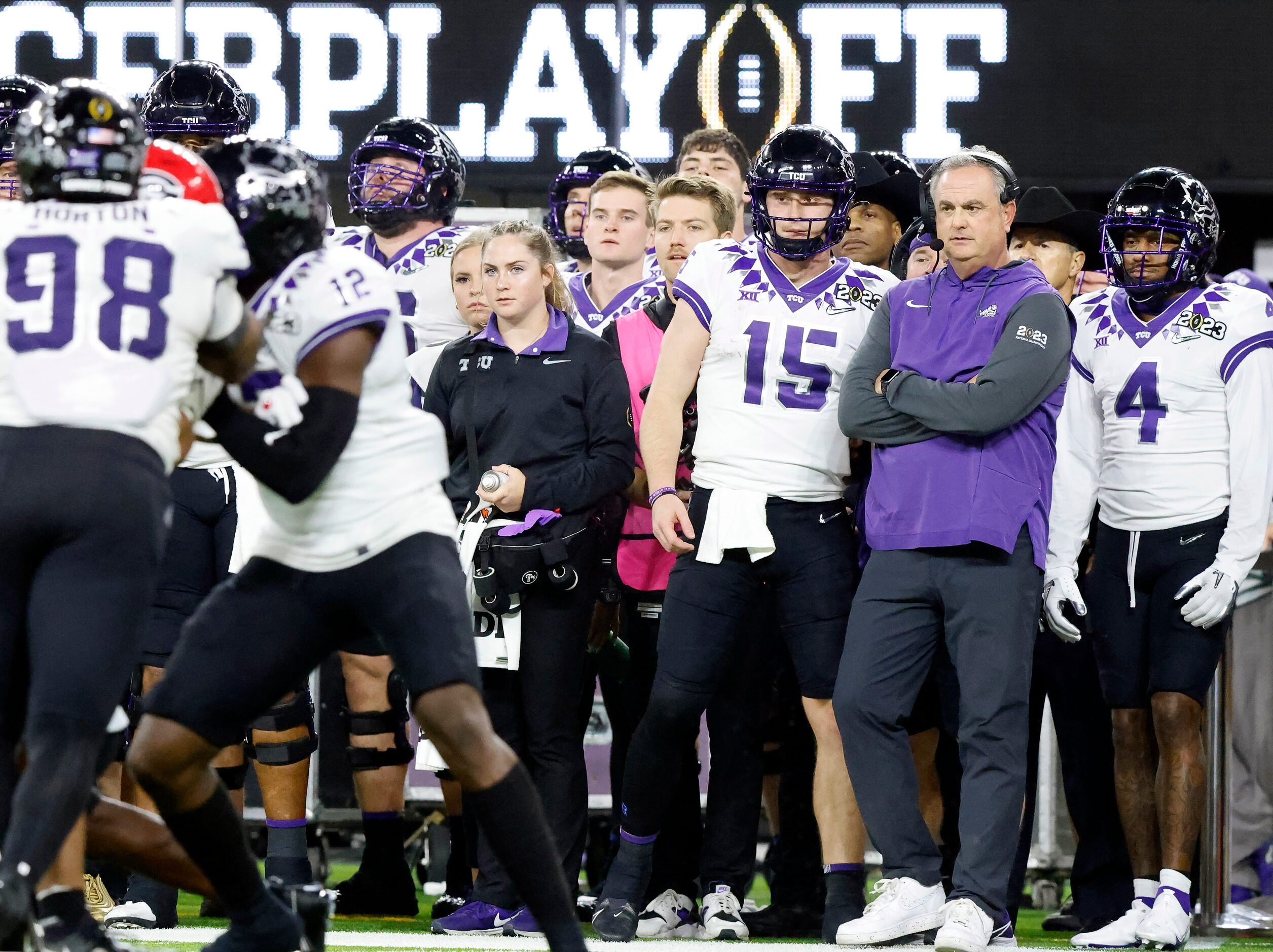 TCU Horned Frogs quarterback Max Duggan (15) and head coach Sonny Dykes can only watch from...