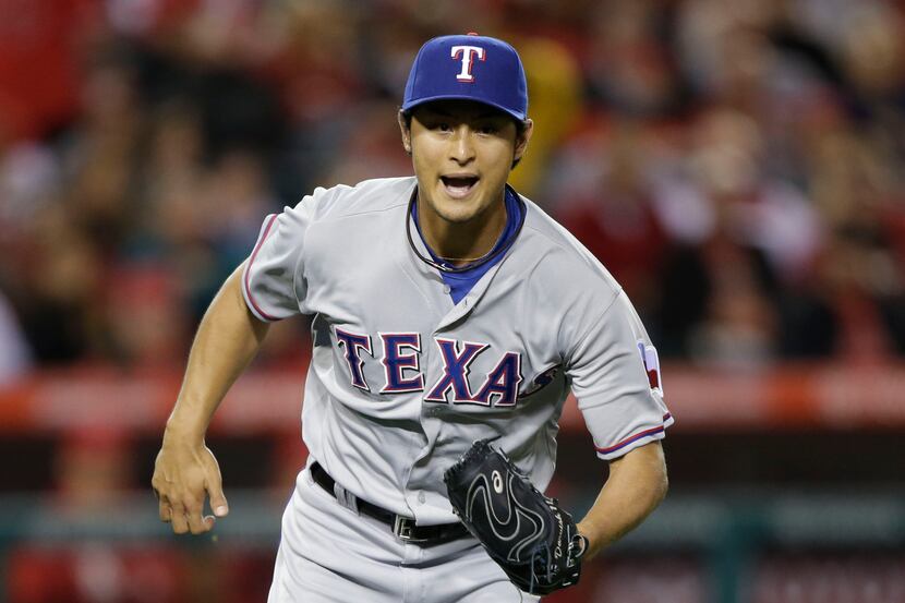Texas Rangers starting pitcher Yu Darvish, of Japan, runs to cover first base during the...