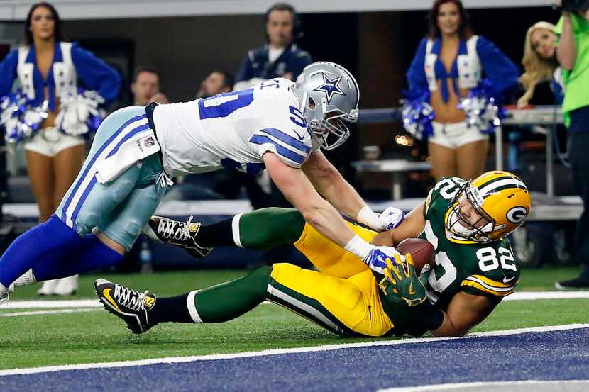 Green Bay Packers tight end Richard Rodgers (82) scores a touchdown as he's tackled by...