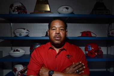 Skyline head football coach Herman Johnson in his office with a collection of football...