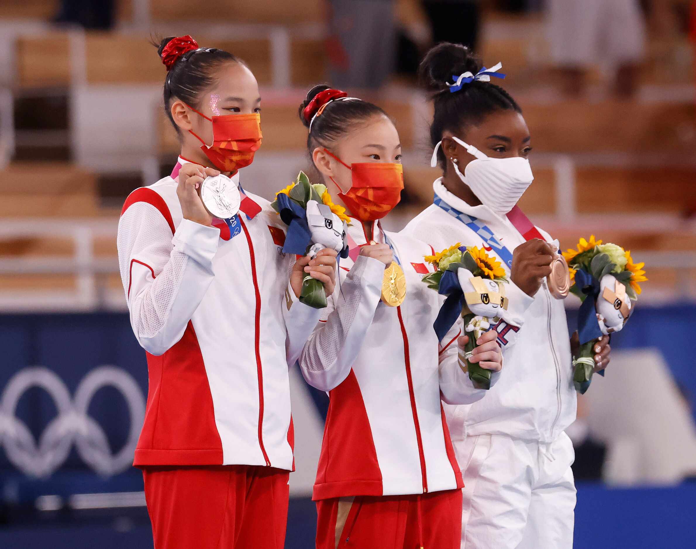 China’s Tang Xijing, China’s Guan Chenchen and USA’s Simone Biles hold up their medals...