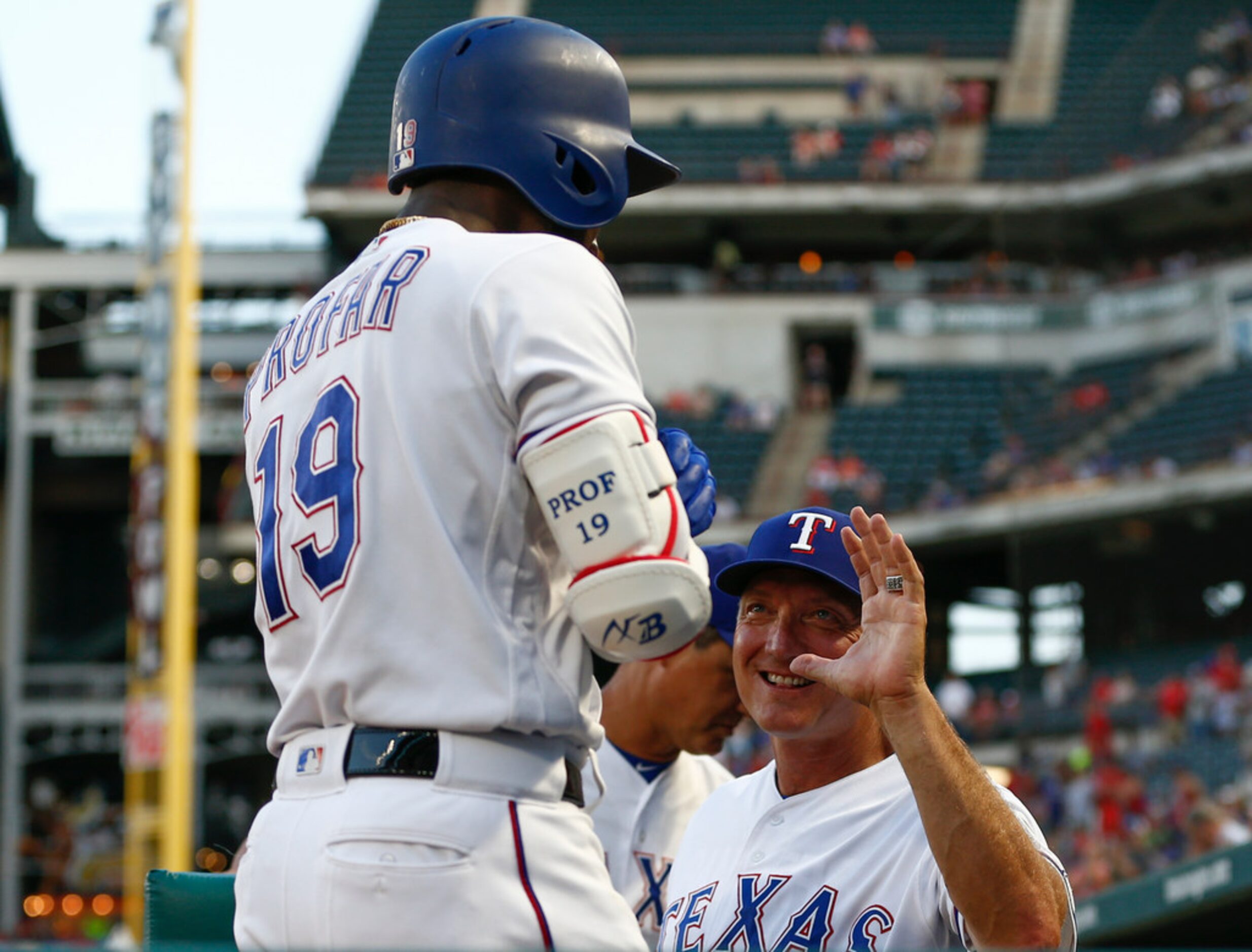 Texas Rangers' Jurickson Profar (19) celebrates his home run with manager Jeff Banister,...