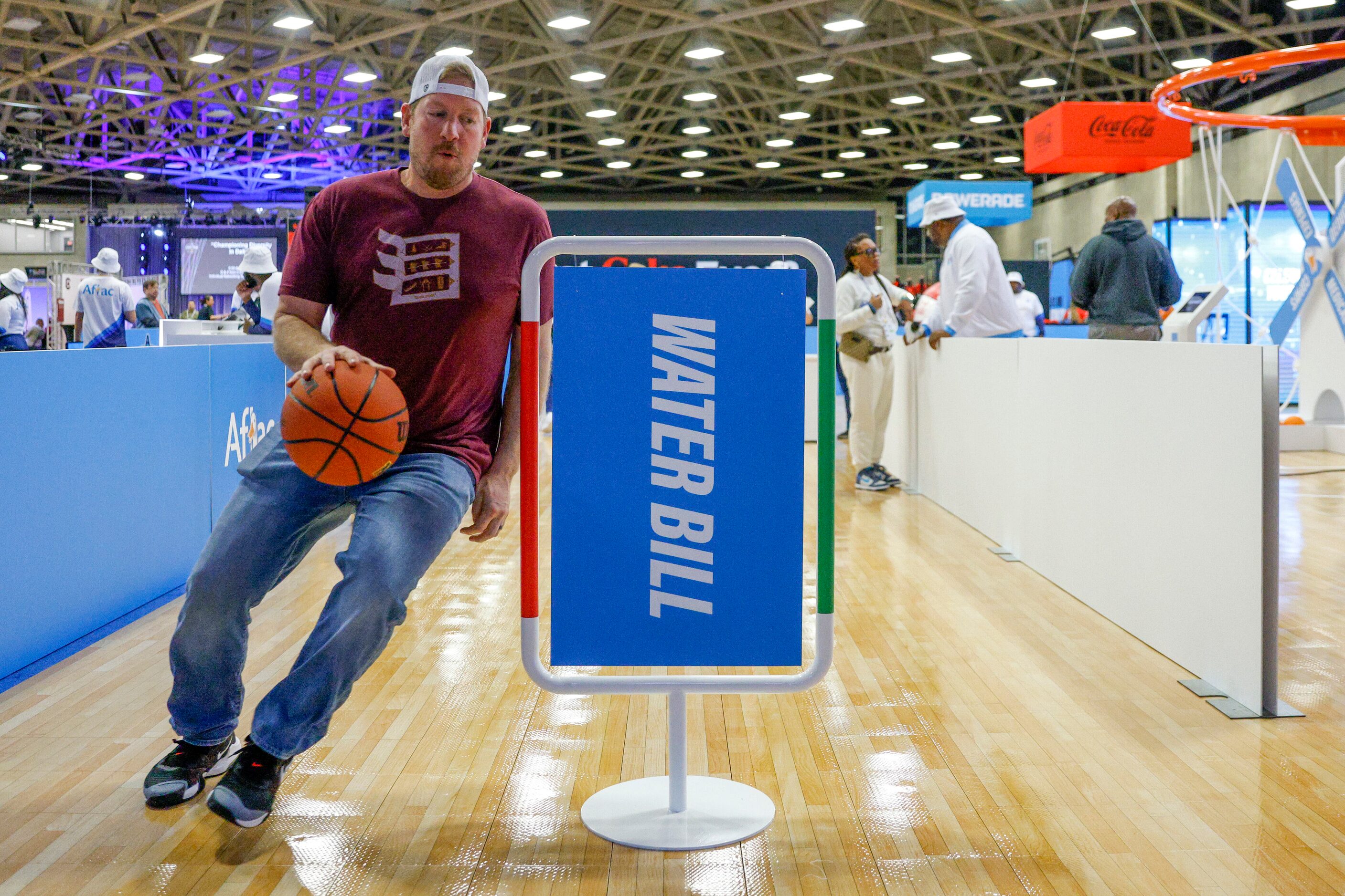 Steve Stauff of Minnesota competes in a basketball skill challenge during the NCAA women’s...