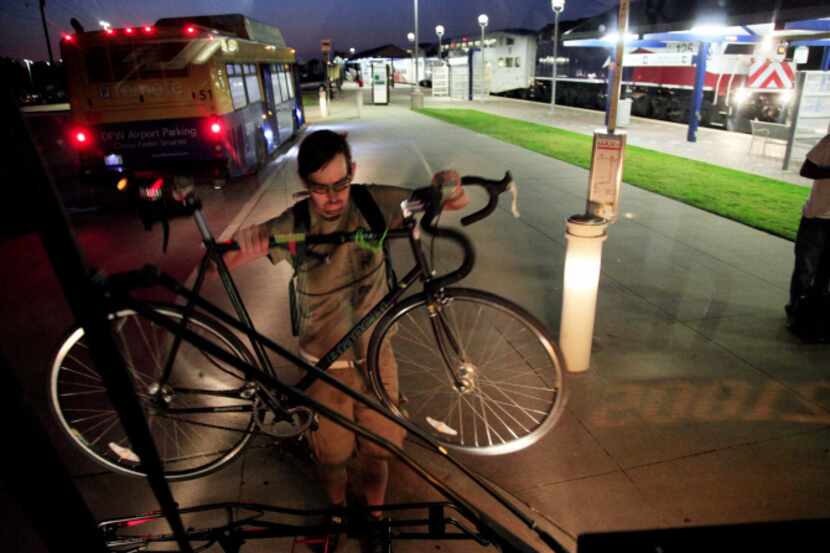 Andrew Tucker places his bike on the bus rack during the first ever transit service route...