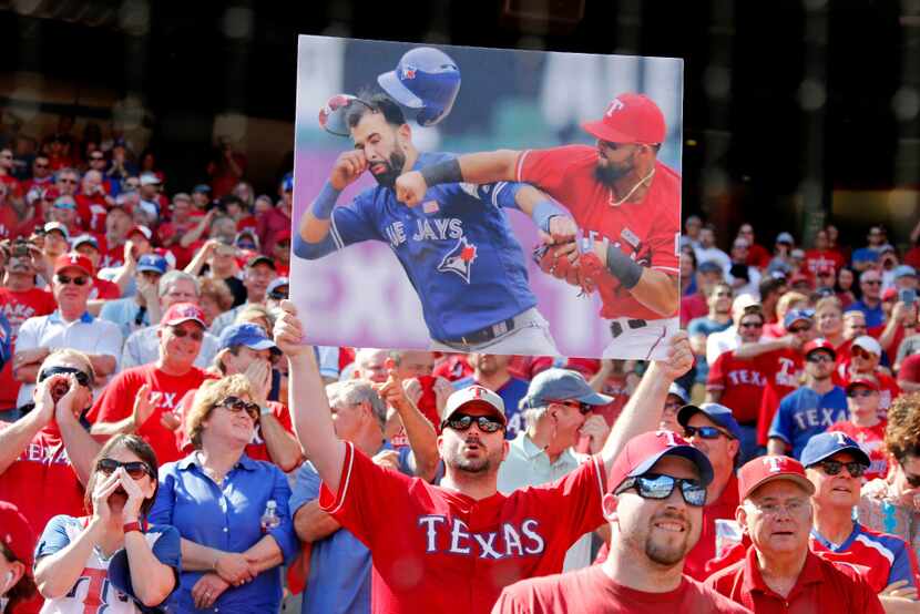 Texas fans jeer Toronto Blue Jays right fielder Jose Bautista -- one fan held up a copy of...