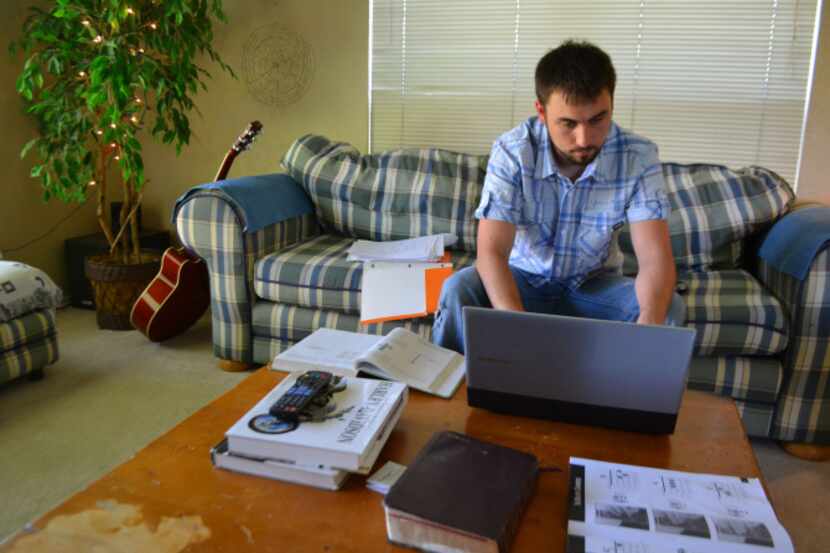 University of Texas at Dallas student Austin Bursby does his homework at his Rowlett home....