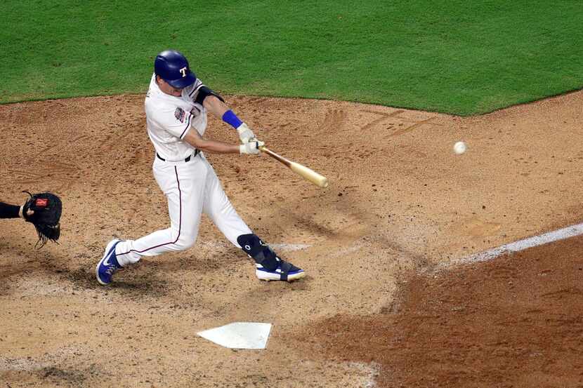 ARLINGTON, TEXAS - SEPTEMBER 12: Nick Solak #15 of the Texas Rangers hits a two-run home run...
