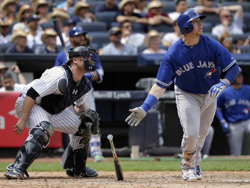 Toronto Blue Jays' Justin Smoak drops his bat after connecting for a grand slam home run as...