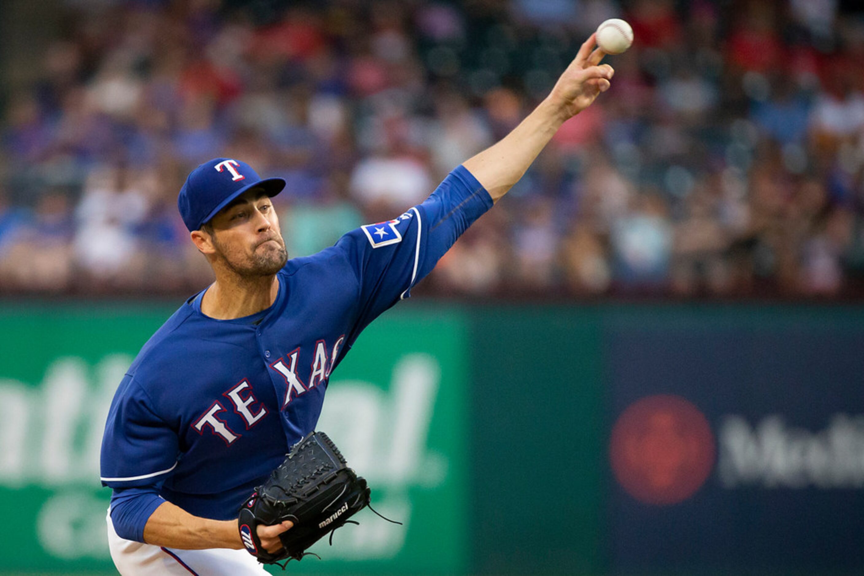 Texas Rangers starting pitcher Cole Hamels delivers a pitch during the first inning against...