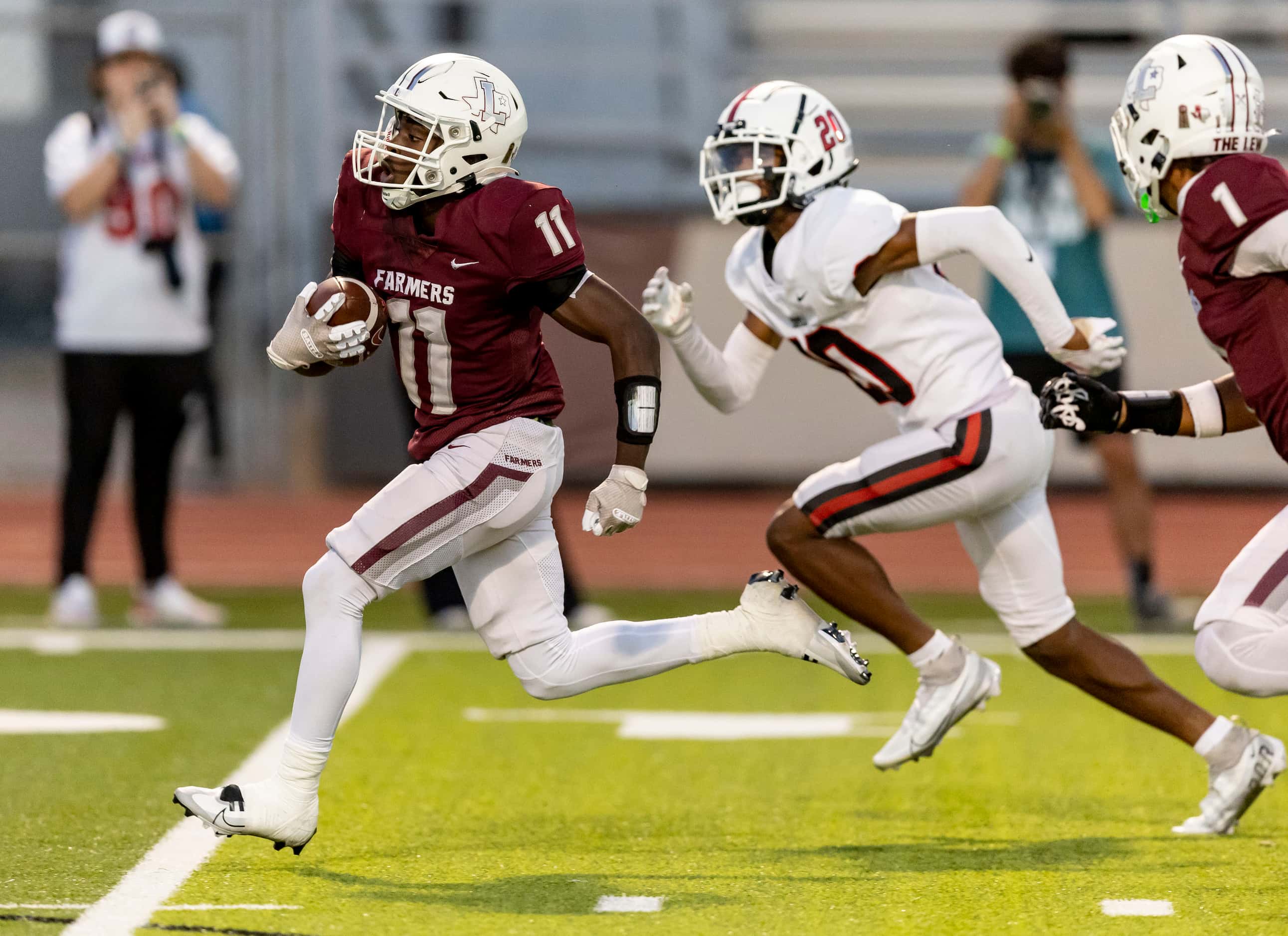 Lewisville senior running back Xavier Lewis (11) carries the ball in for a touchdown as...