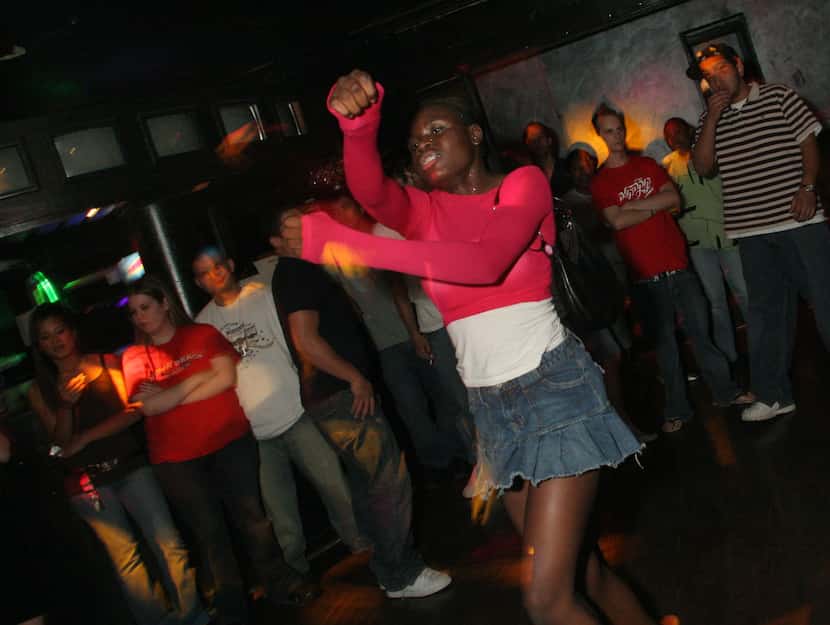 A woman who calls herself "Ray of Light" dances at the Lizard Lounge in 2006. 