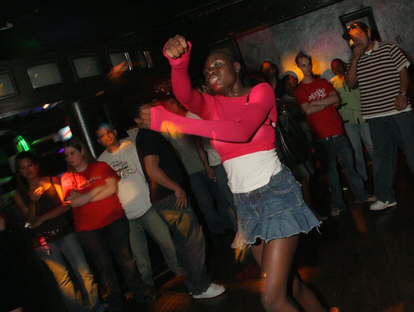 A woman who calls herself "Ray of Light" dances at the Lizard Lounge in 2006. 