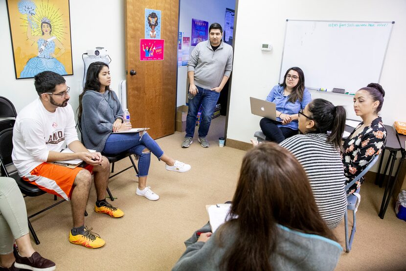 David Sanchez, civics engagement director at Jolt, center, stands and listens during a Jolt...