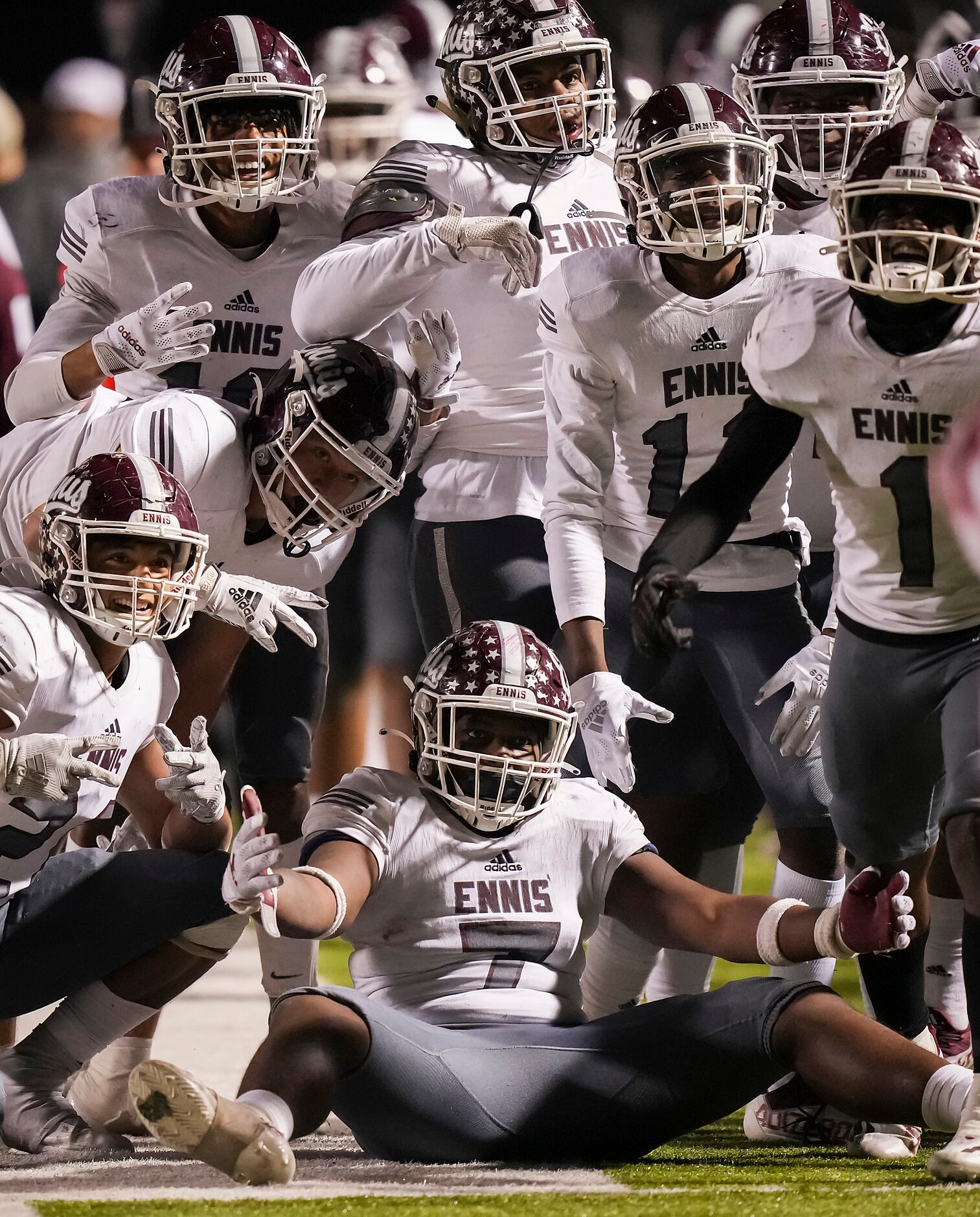 Ennis defenders, including defensive lineman TJ Johnson (7) celebrate an interception by...