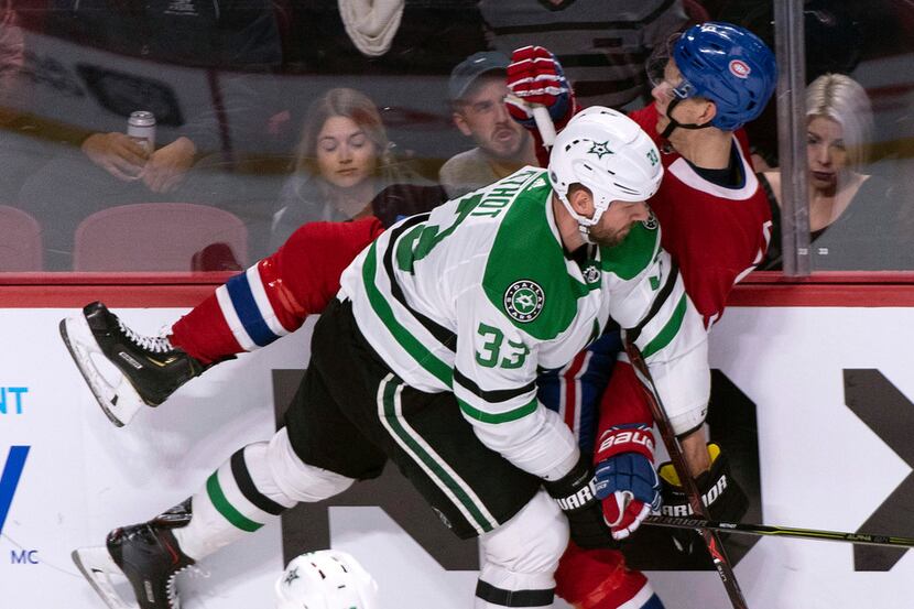 Montreal Canadiens' Jesperi Kotkaniemi is taken into the boards by Dallas Stars' Marc Methot...