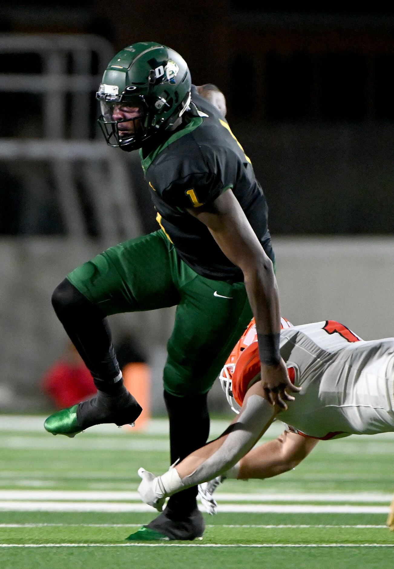 DeSoto quarterback Samari Collier tries to get away from Rockwall’s Gage Elder in the first...