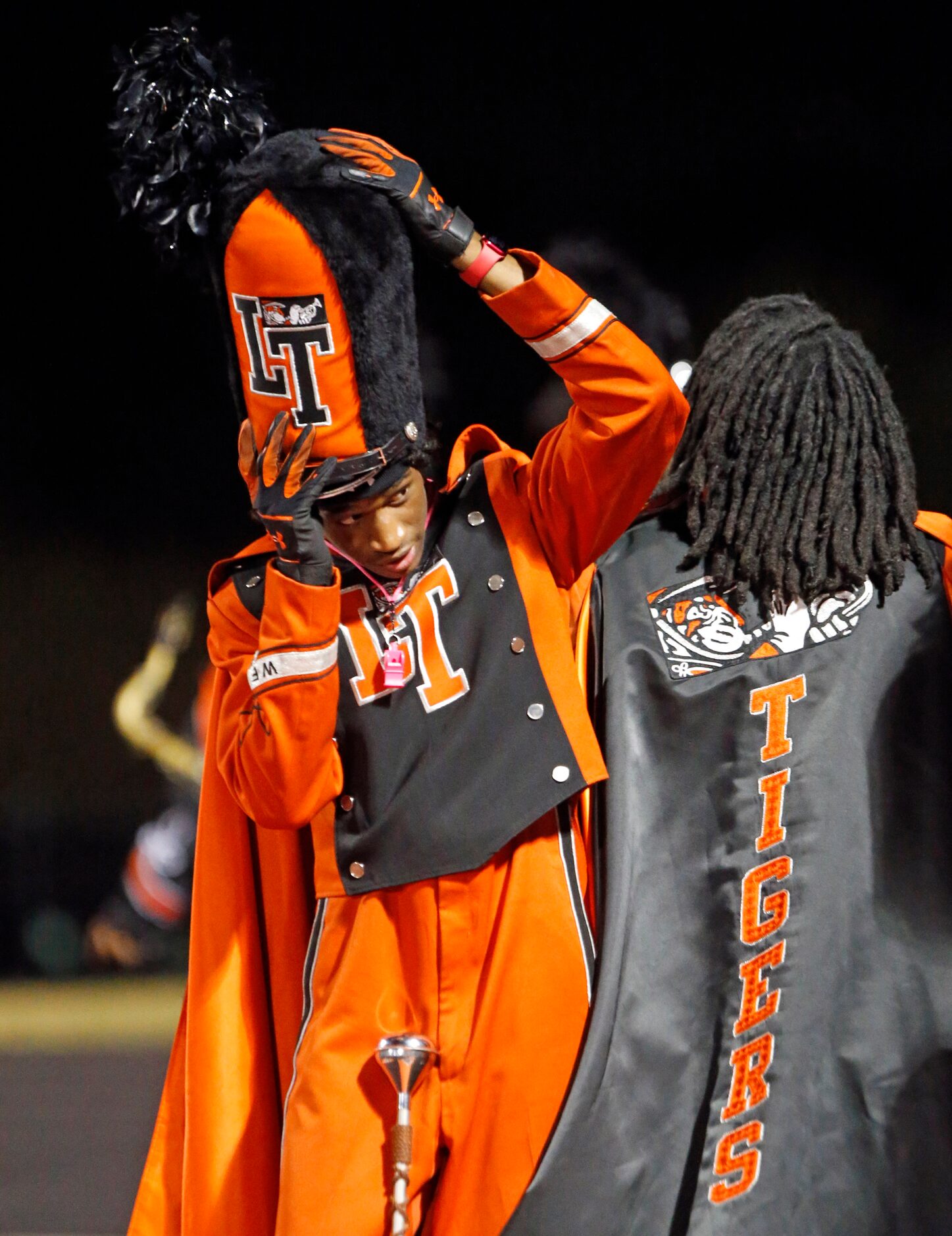 A Lancaster band leader adjusts his headgear before taking the field at the end the first...