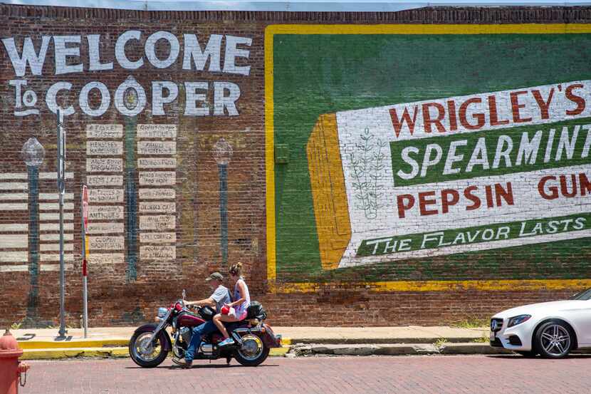 A motorcyclist passes by a signature landmark of Cooper, Texas, on Thursday, July 11, 2019....