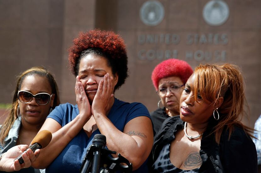 Shaquna Persley, mother of slain 13 yr-old Shavon Randle, is overcome with emotion as she...