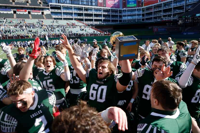 Prosper’s Nash Gagliano (60) holds the semifinal trophy after they defeated Northwest Eaton...