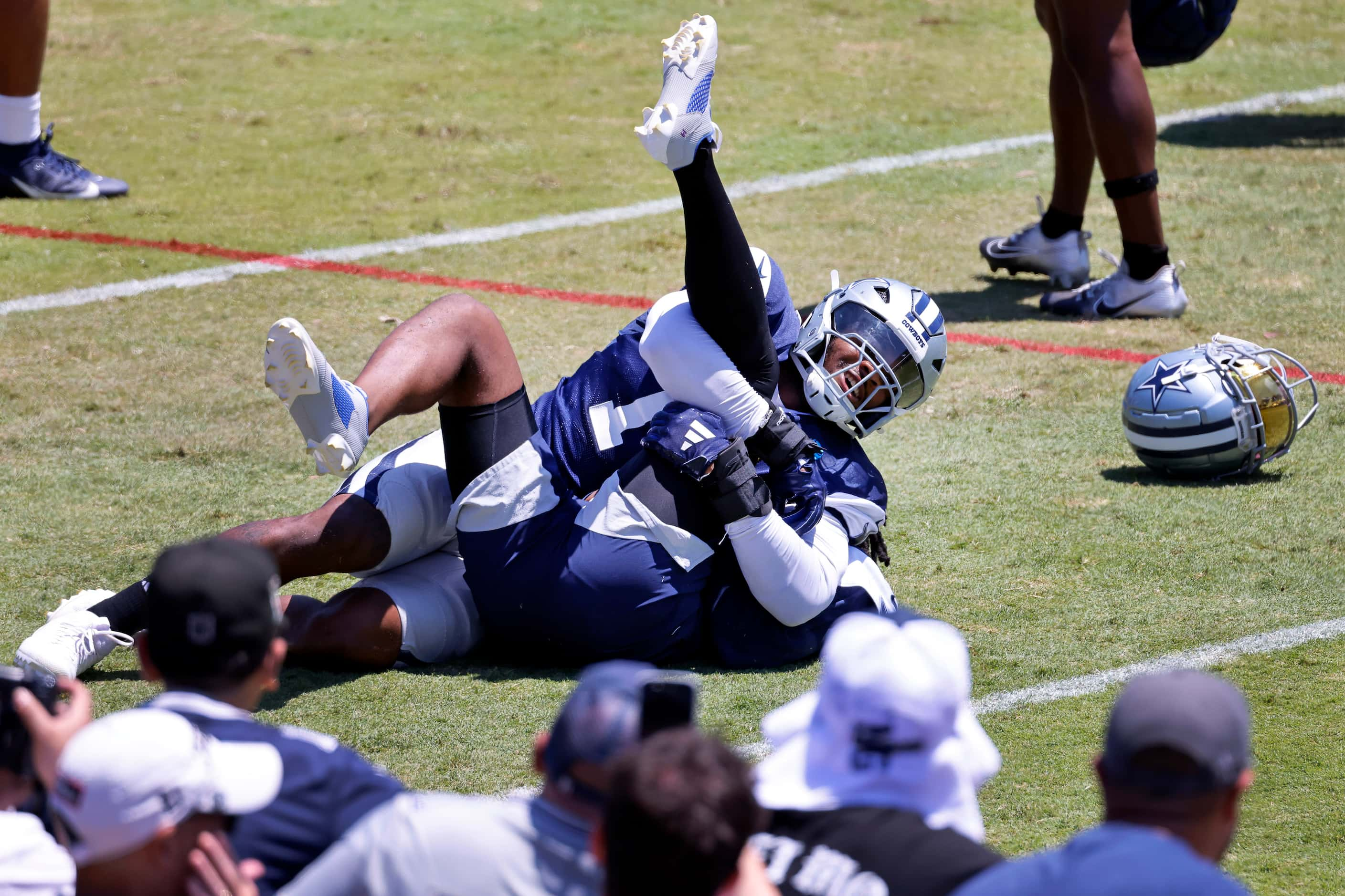 Dallas Cowboys linebacker Micah Parsons (11) pins cornerback Trevon Diggs (7) as the two...