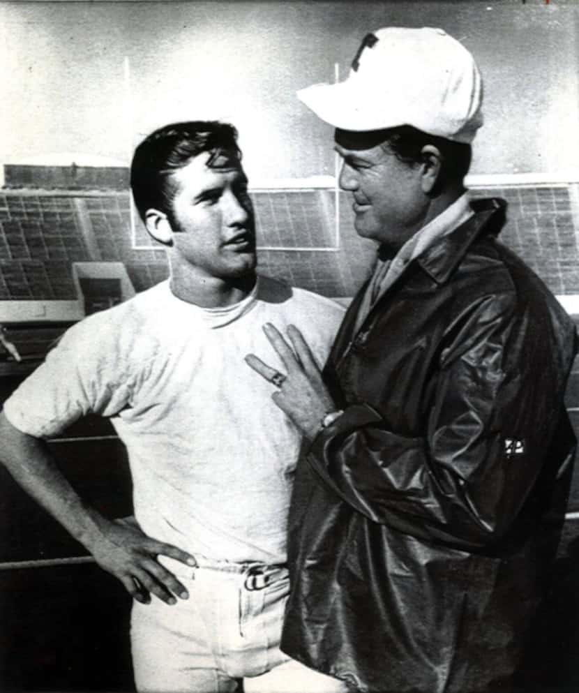 This is a 1969 photo of head coach Darrell Royal, right, speaking with James Street,...