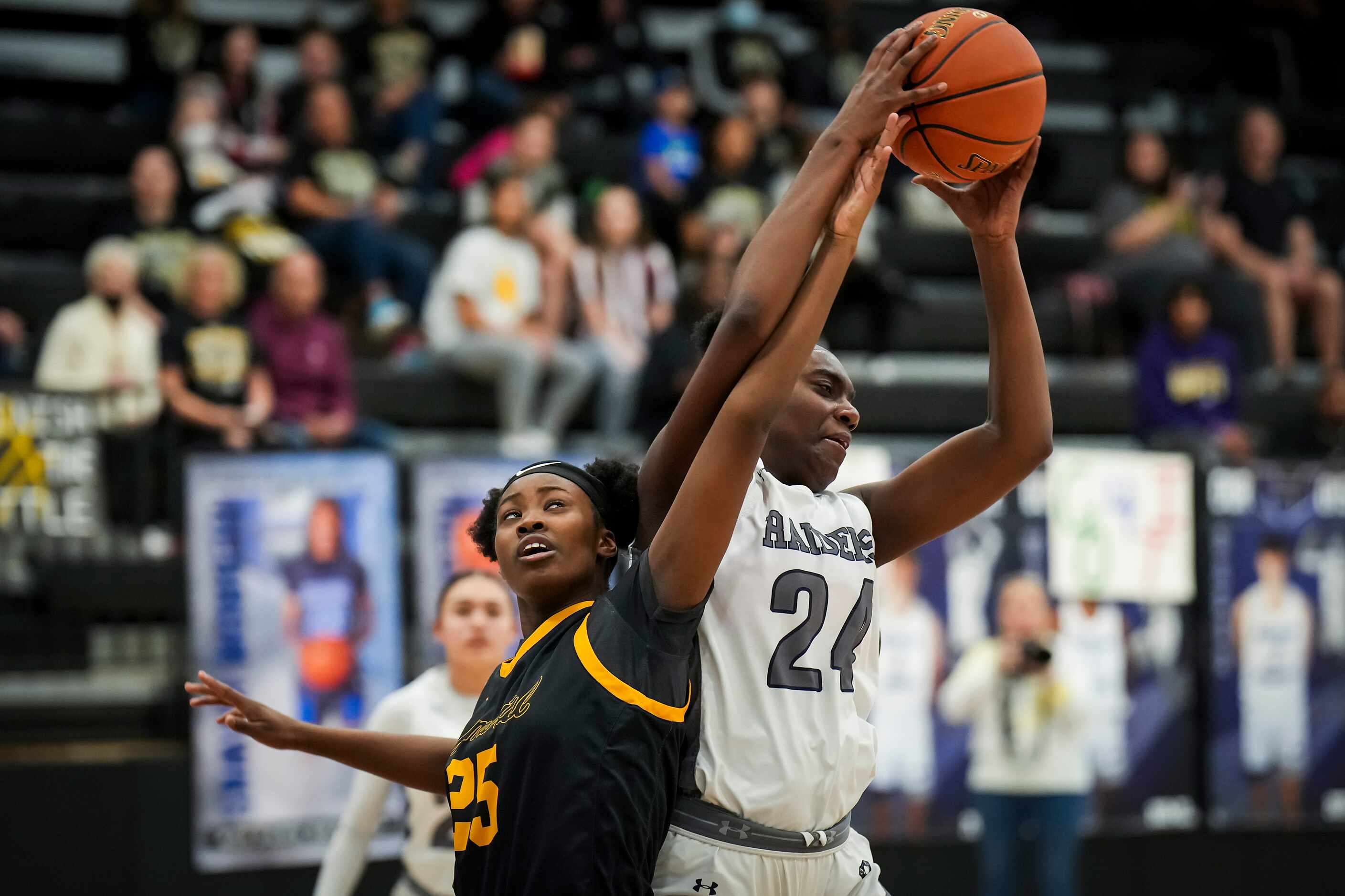 Frisco Memorial's Makayla Vation (25) fights for a rebound against Wylie East's LeAire Nicks...