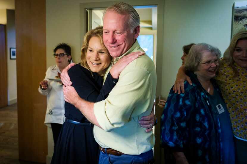 Dallas City Council member Jennifer Staubach Gates hugs husband John Gates as early voting...