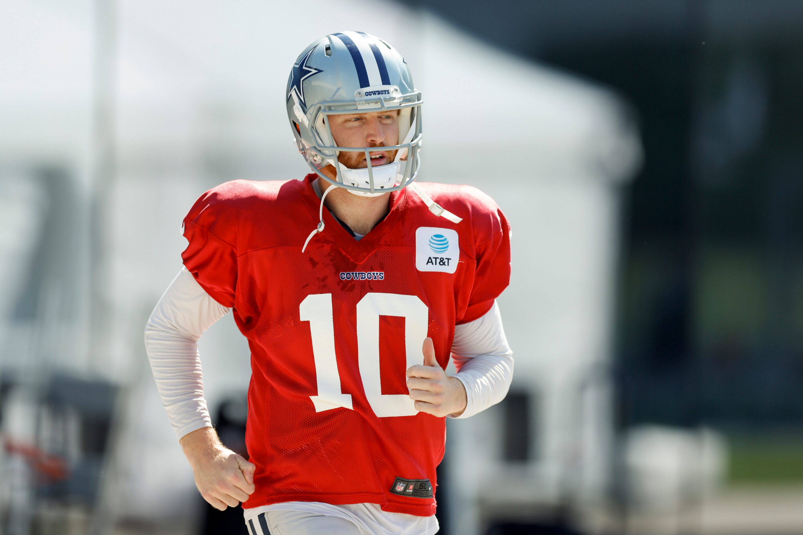 Dallas Cowboys quarterback Cooper Rush (10) jogs to the field during a practice at The Star,...