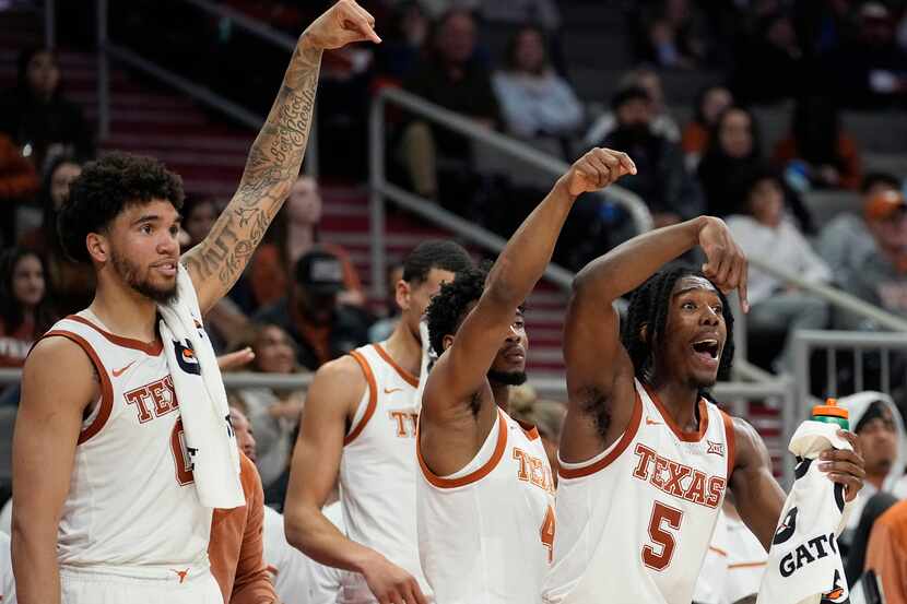 Texas forward Timmy Allen (0), guard Tyrese Hunter (4) and guard Marcus Carr (5) reacts to a...