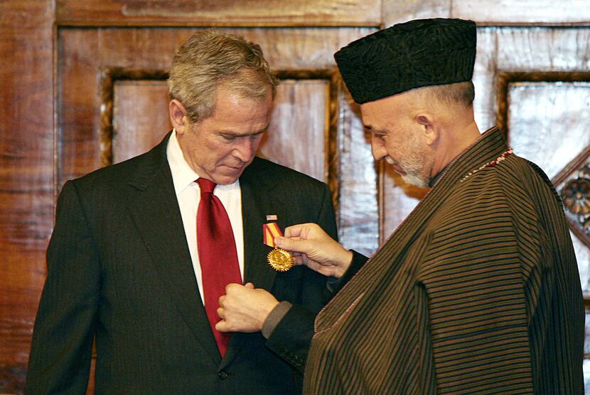 Afghanistan's President Hamid Karzai presented President George W. Bush with a medal at the...