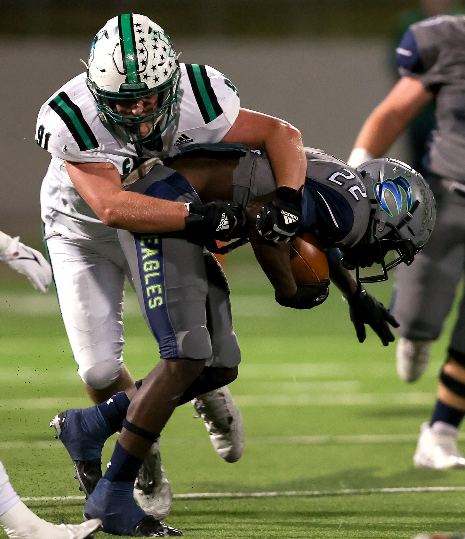 Eaton running back JB Brown (22) pulled down by Southlake Carroll defensive lineman Calder...