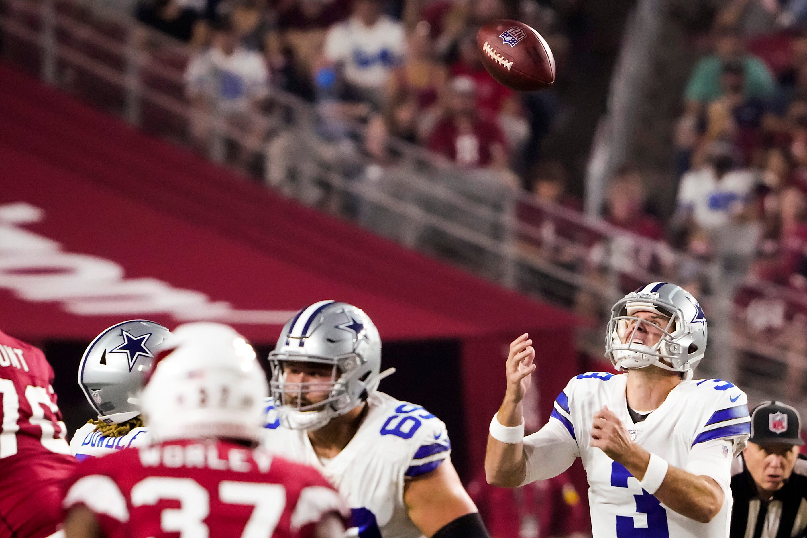 Dallas Cowboys quarterback Garrett Gilbert (3) reaches for a high snap during the first...