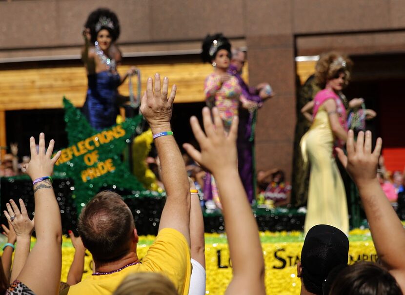 People in the crowd plead for beads during the Alan Ross Texas Freedom Parade on Cedar...