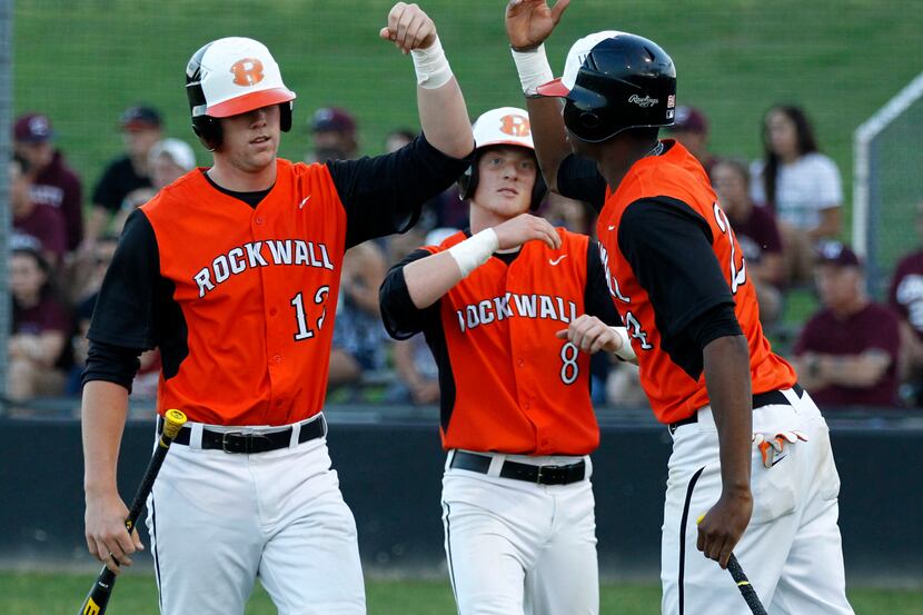 Rockwall High's Nick Lutzel (13) and Dustin Angiel (8) celebrate with teammate Kendall...