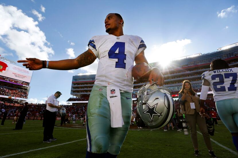 Dallas Cowboys quarterback Dak Prescott (4) walks ff the field after his 24-17 win over the...