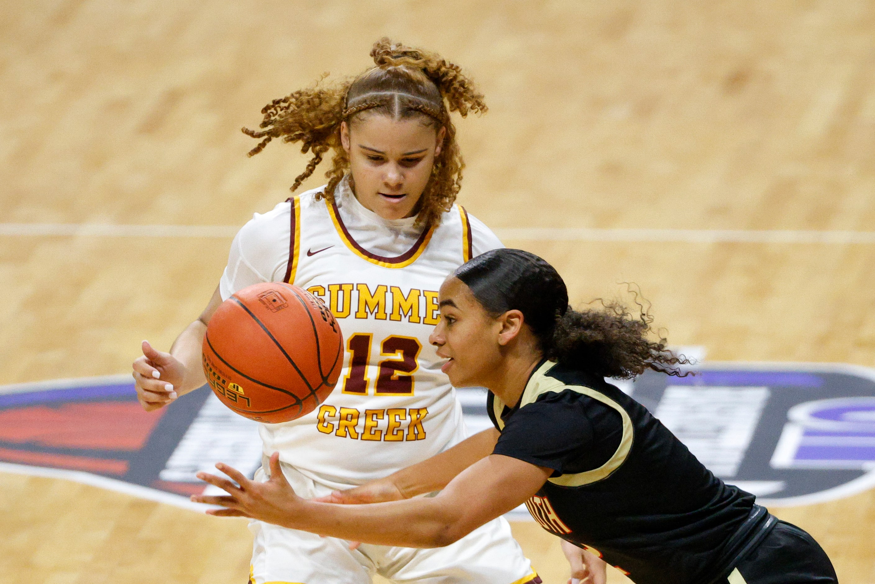 South Grand Prairie guard Ahrianna Morgan (2) reaches for the ball alongside Humble Summer...