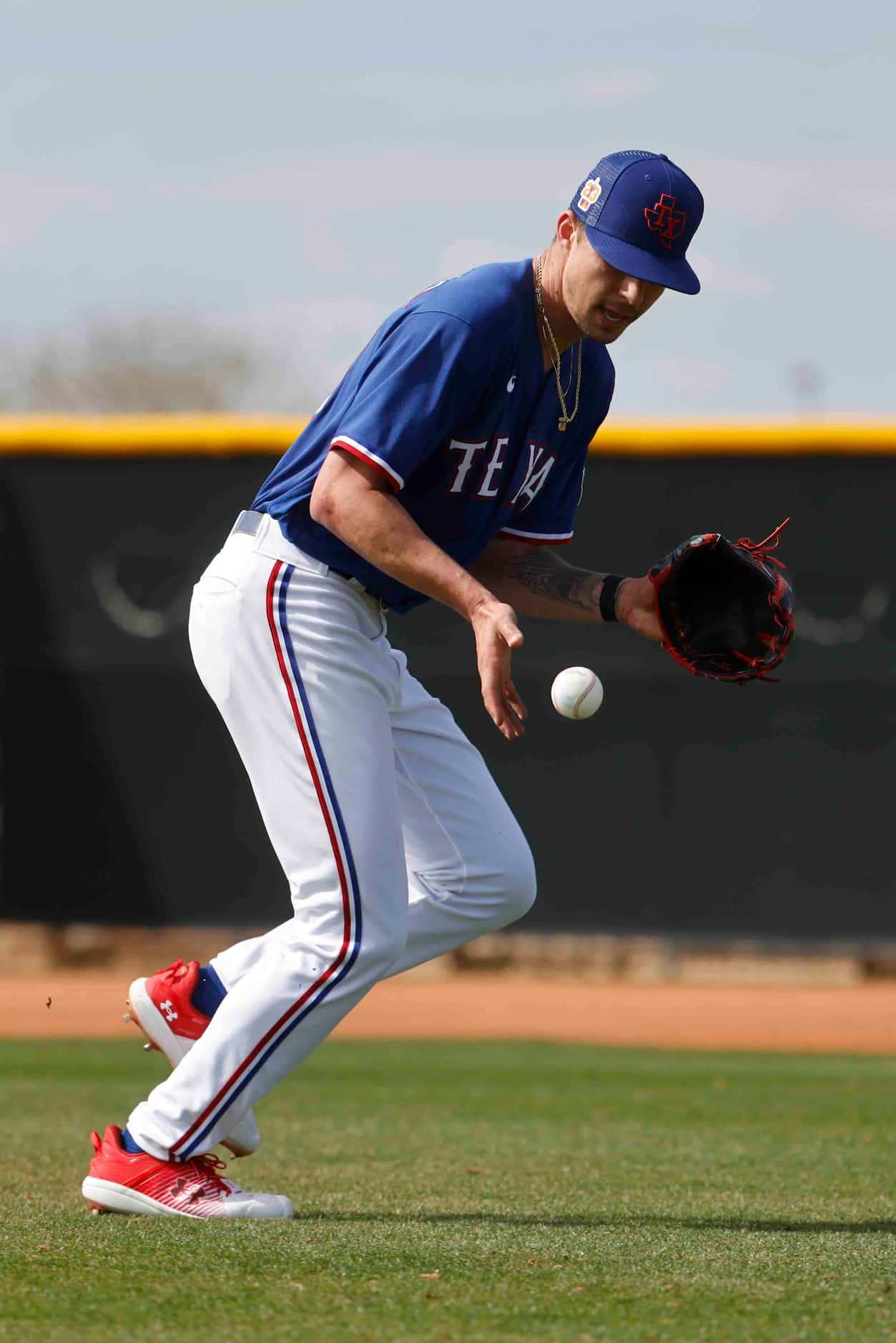 Texas Rangers pitcher Ricky Vanasco fields a ball during a spring training workout at the...