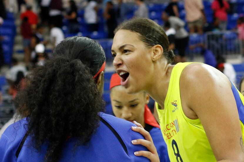 Dallas Wings center Liz Cambage (8) celebrates with teammates following their 77-67 victory...