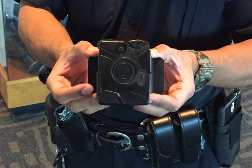 A Dallas police officer holds a Taser Axon Flex body camera at Jack Evans Police...