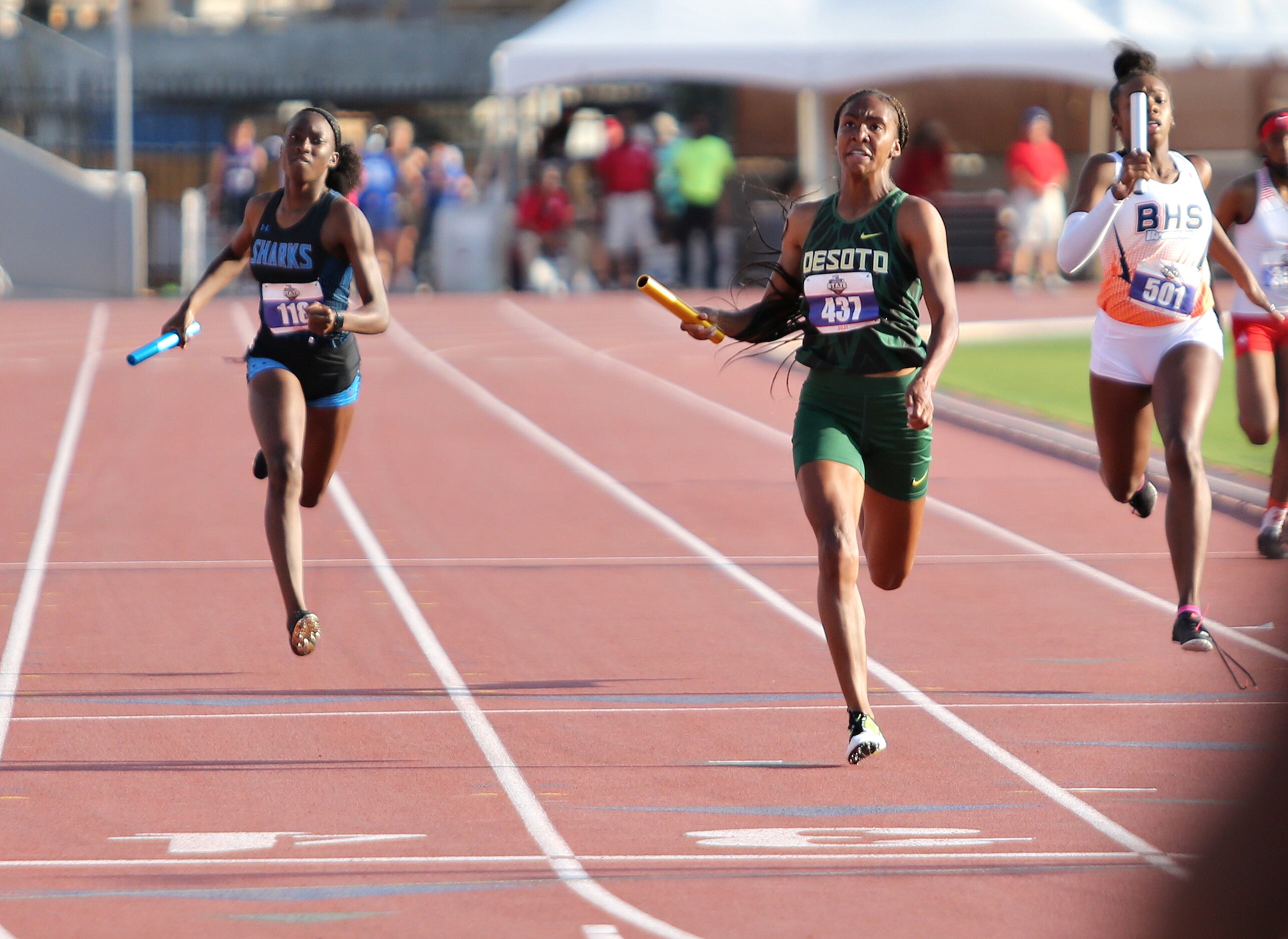 Logan Neely of DeSoto crosses the finish line in first place at the 6A Girls 4x200 meter...