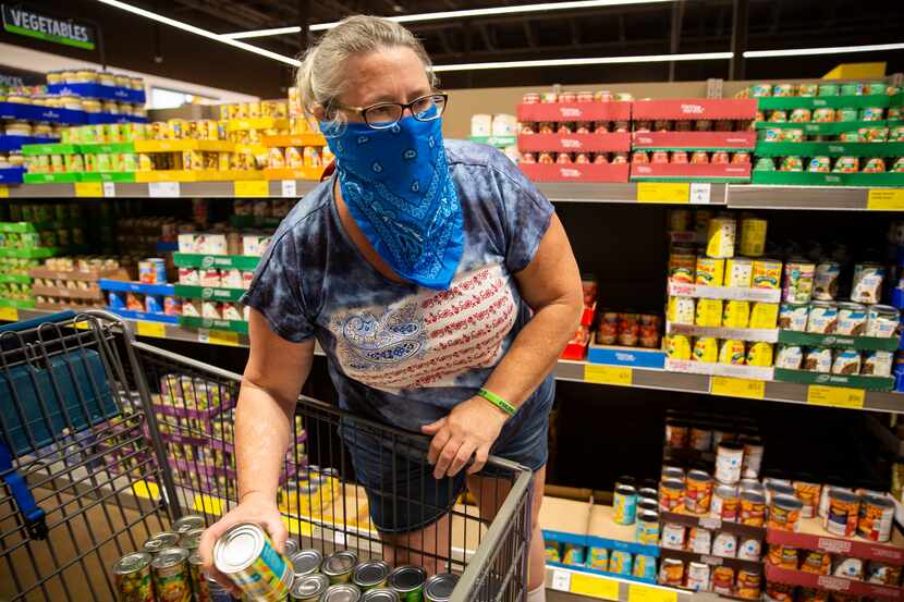 A woman shops for donations she plans to give to North Texas Food Bank at Aldi on Saturday,...