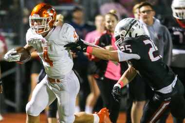 Celina running back Logan Point carries the ball past Melissa linebacker Caden Hayes (25)...