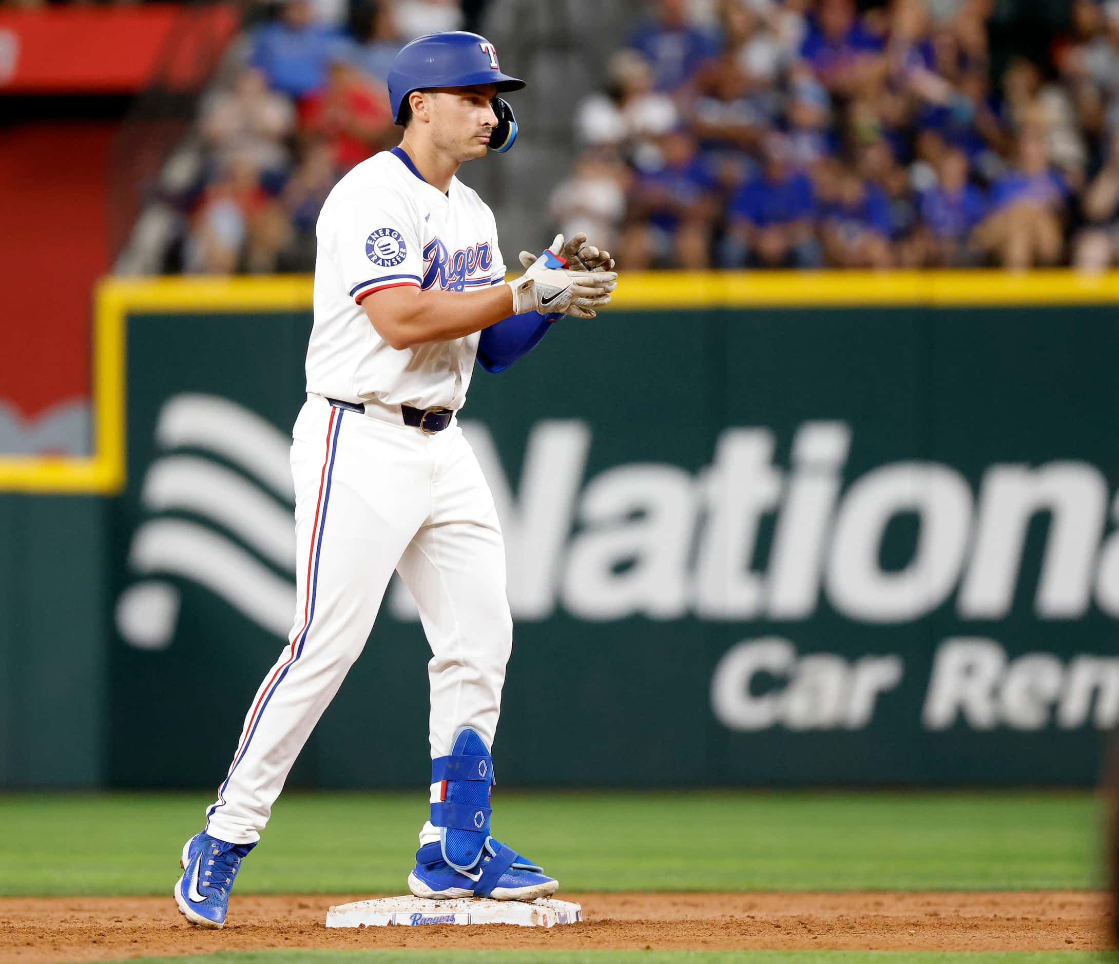 Texas Rangers designated hitter Justin Foscue applauds as he reaches second bae on a second...