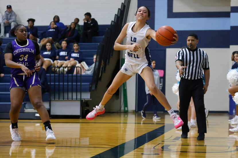 Hurst L.D. Bell guard Enyce Williams (11) attempts to save the ball from going out of bounds...